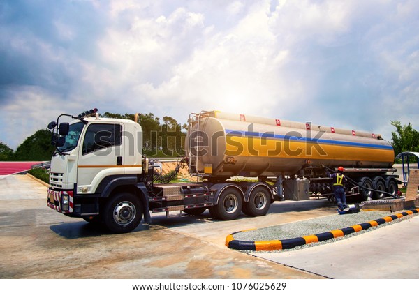 Technician is releasing\
fuel oil from trucks