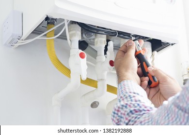 Technician repairing gas heater at home
