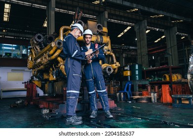 The Technician Repairing And Inspecting The Big Diesel Engine In The Train Garage