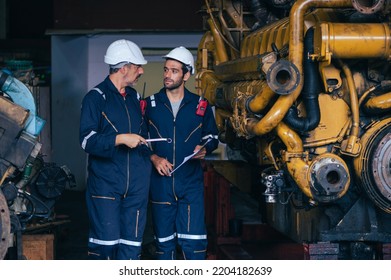 The Technician Repairing And Inspecting The Big Diesel Engine In The Train Garage