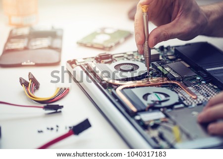 technician repairing laptop computer closeup