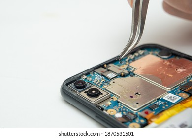 The technician repairing the smartphone in the lab with copy space. the concept of computer hardware, mobile phone, electronic, repairing, upgrade and technology.