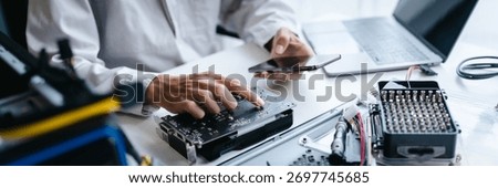 A technician repairs PC hardware components in a engineering lab