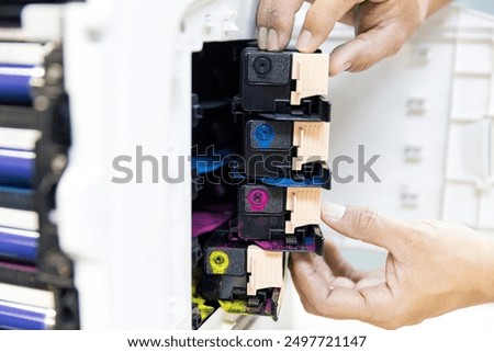 Technician replace ink cartridges of printer toner low and fix repair problem paper or print scanning fax or copy document or photocopier or photocopy office workplace equipment concept