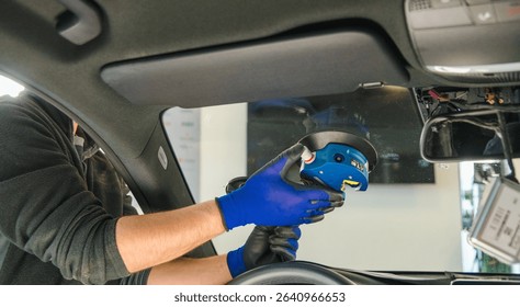 Technician Replacing Windshield with Specialized Tool Car Workshop Visual