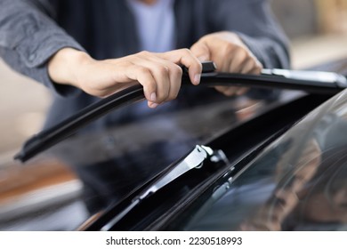 Technician replacing windshield wipers change car wiper blades