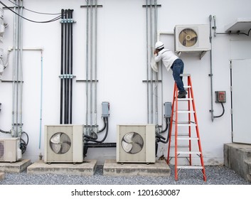 Technician Routiens Inspec And Repairing Air Conditioner (Condensing Unit).