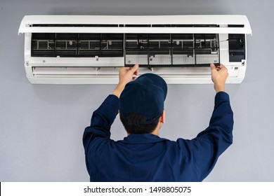 technician service removing air filter of the air conditioner for cleaning