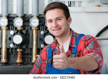 Technician Servicing The Gas Boiler For Hot Water And Heating