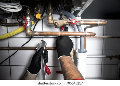 Technician servicing heating boiler
