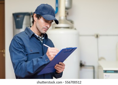 Technician servicing an hot-water heater - Shutterstock ID 556700512