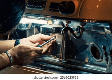 Technician skillfully using screwdriver removing nut from coffee maker on counterbar in coffee shop. Process service of equipment maintenance in beverage industry