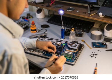 Technician Soldering A Broken Computer Board