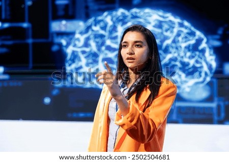 IT technician speaking at tech event, explaining impact of AI technology on world. Woman presenting risks and threats associated with AI during conference, pointing to screen