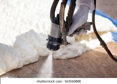 Technician Spraying Foam Insulation Using Plural Component Spray Gun