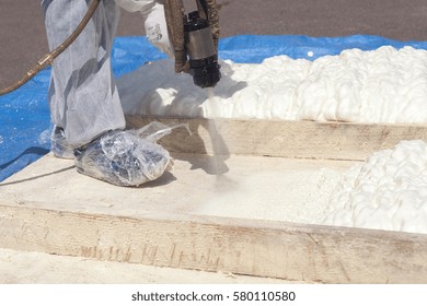 Technician Spraying Foam Insulation Using Plural Component Spray Gun