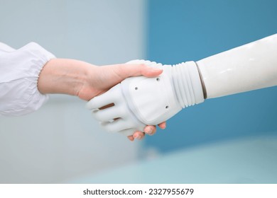 Technician testing robotic bionic arm at prosthetic manufacturing