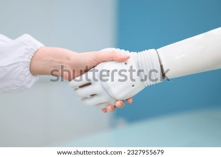 Technician testing robotic bionic arm at prosthetic manufacturing