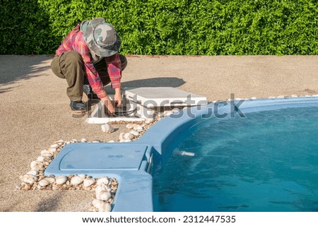 Technician trying to fix swimming pool pumps. The pump keeps the water moving and prevents stagnation while the filter removes debris and contaminants.