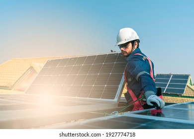 A Technician Use A The Electric Drill Installing The Solar Panels At Roof Top Of Home And Home Office ,concept Of Economic Energy And Cost Saving