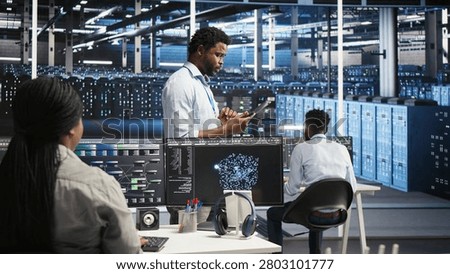 Technician uses a computer workstation in a server farm to categorize unstructured data with node tree systems.