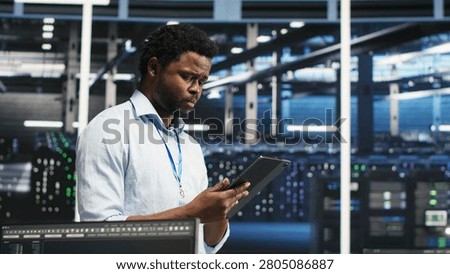 Technician uses a computer workstation in a server farm to categorize unstructured data with node tree systems.