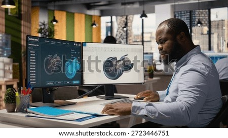 Technician using CAD program on PC to optimize wind turbine design, reducing carbon footprint. RD department employee testing advanced materials for eco friendly windmill components, camera A