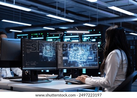 Technician using computer to do checkup in server room providing vast computing resources and storage, enabling artificial intelligence to process massive datasets for training and inference