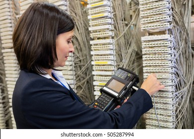 Technician using digital cable analyzer in server room