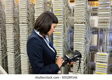 Technician using digital cable analyzer in server room