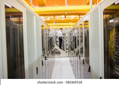 Technician using digital cable analyzer in server room