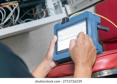 A technician is using a handheld device for data entry in a modern workspace. This image captures technology in action, emphasizing tools and workflow efficiency.