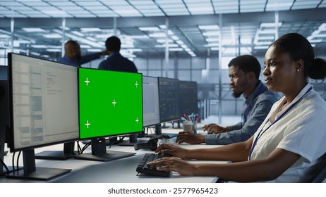 Technician using isolated screen computer, working in server farm to optimize it for data processing requirements. IT professional coding on chroma key PC in data center, camera A