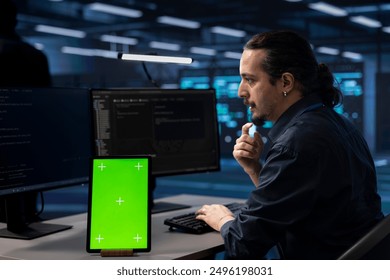 Technician using isolated screen screen tablet to check for signs of imminent failure in data center. IT expert working on mockup device to prevent damages in server farm, monitoring critical systems