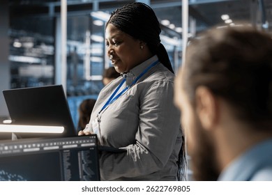 Técnico que usa laptop para supervisionar o treinamento de algoritmos de alimentação da infraestrutura de servidores e tarefas de inferência de dados. Funcionário que usa o bloco de anotações para fazer manutenção em supercomputadores que dão suporte à carga de trabalho de análise