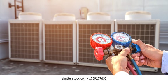 Technician Using Manifold Gauge Is Measuring Equipment For Filling Industrial Factory Air Conditioners And Checking Maintenance Outdoor Air Compressor Unit.