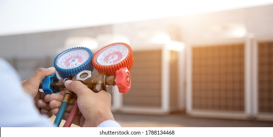 Technician Using Manifold Gauge Is Measuring Equipment For Filling Industrial Factory Air Conditioners And Checking Maintenance Outdoor Air Compressor Unit.