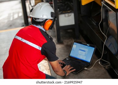 
A Technician Using Safety Equipment Is Performing Maintenance On A Diesel Engine At A Power Plant At A Private Power Plant In Bangka Belitung.  November 14th 2014