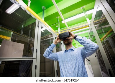 Technician using virtual reality headset in server room