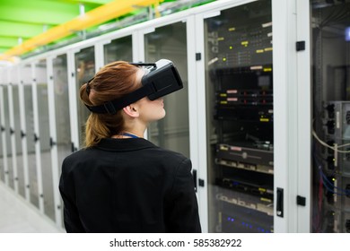 Technician using virtual reality headset in server room