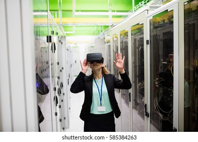 Technician using virtual reality headset in server room