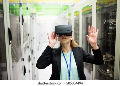 Technician using virtual reality headset in server room