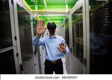 Technician using virtual reality headset in server room