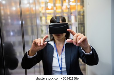 Technician using visual reality headset in hallway of server room