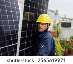 Technician wearing a yellow safety helmet carefully positions solar panels on a rooftop, contributing to sustainable energy solutions and reducing carbon footprint