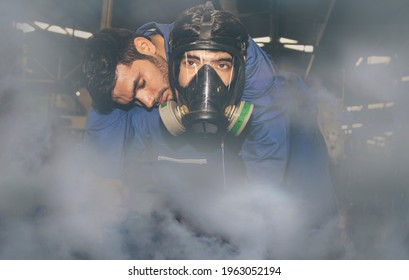 Technician wears an NH3 ammonia protective mask to help an unconscious colleague suffocate urgently due to the violent ammonia gas leaking in the work area in the frozen food industry :Selective focus