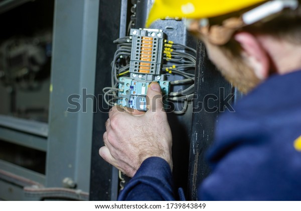 technician at\
work, technician repairing\
electricity