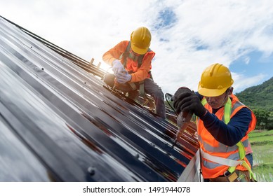 Technician is Work Roof Repair Construction engineer wear safety uniform inspection metal roofing work for roof 