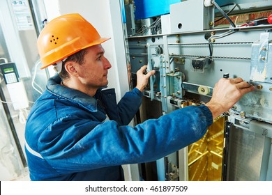 technician worker adjusting elevator mechanism of lift - Powered by Shutterstock