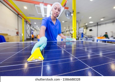 Technician Worker Cleaning New Solar Panel On Production Line On Factory Floor